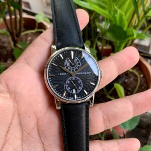 black dial watch with black leather strap