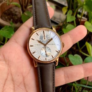 white dial watch with brown leather strap