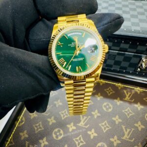 green dial with gold chain