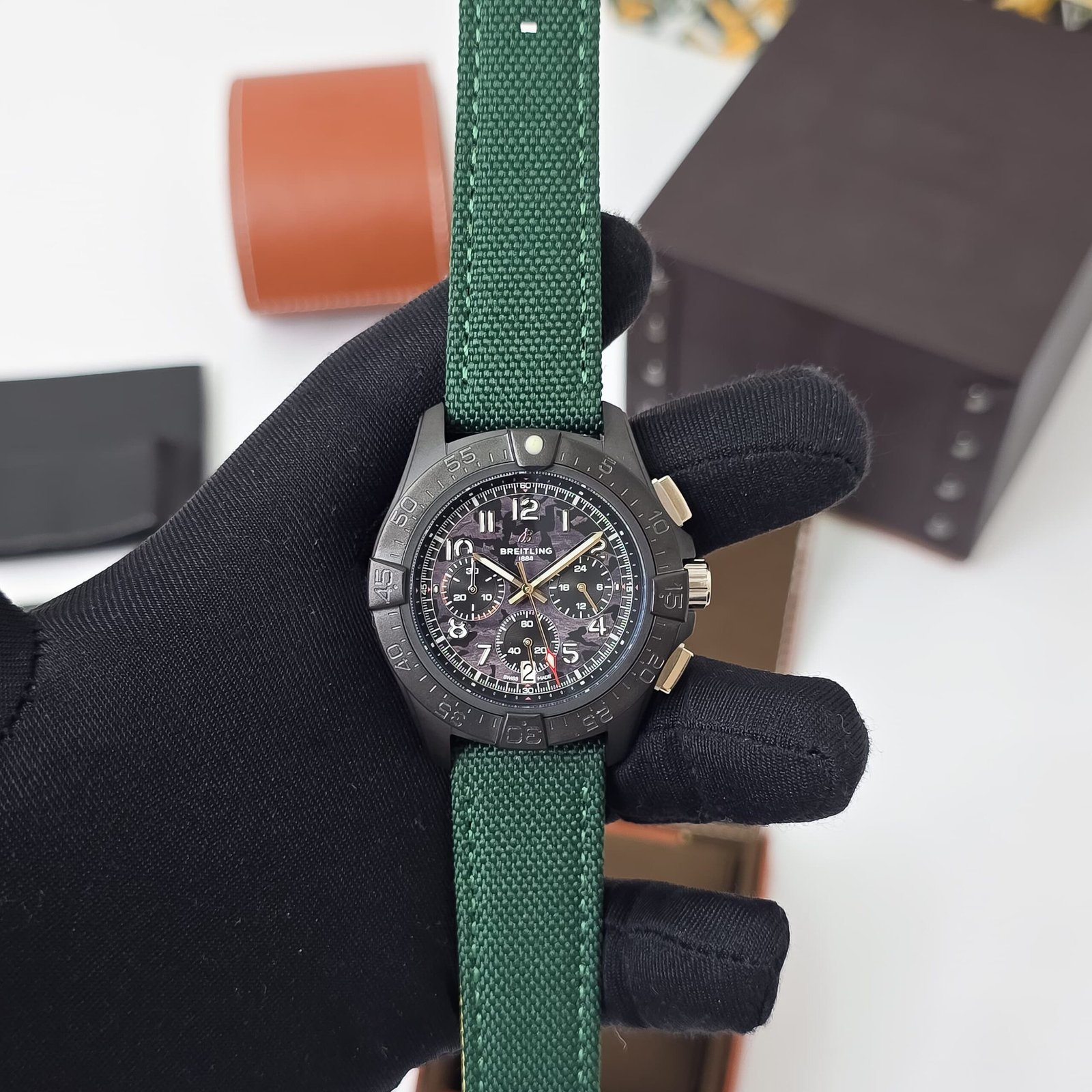 black chronograph dial with green strap